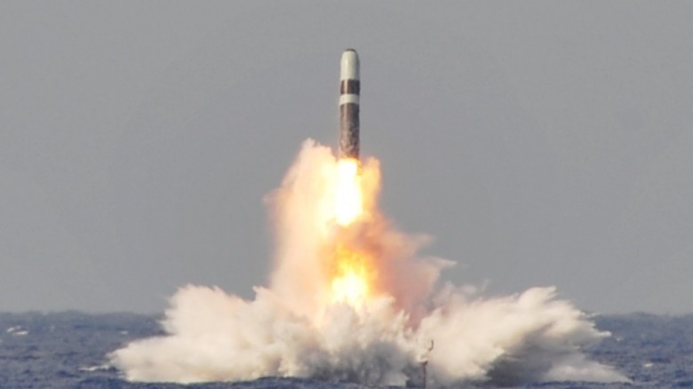 A Titan II missile breaks the water surface.