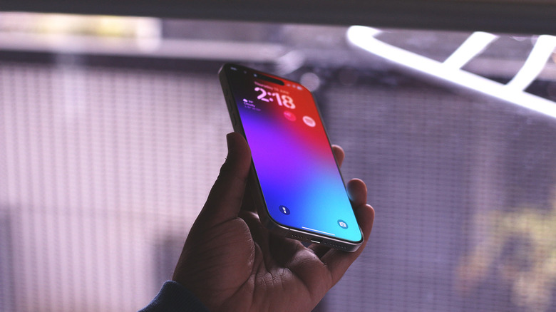 iPhone in hand with screen protector