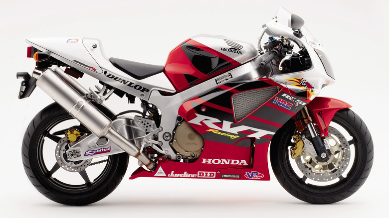 A side view of the Honda RC51, finished here in red and white livery, against a white studio background.