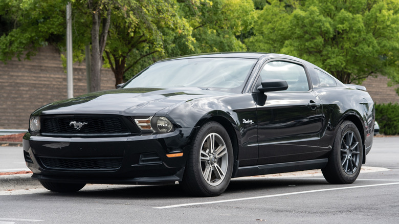A black 2012 Ford Mustang parked in a parking lot