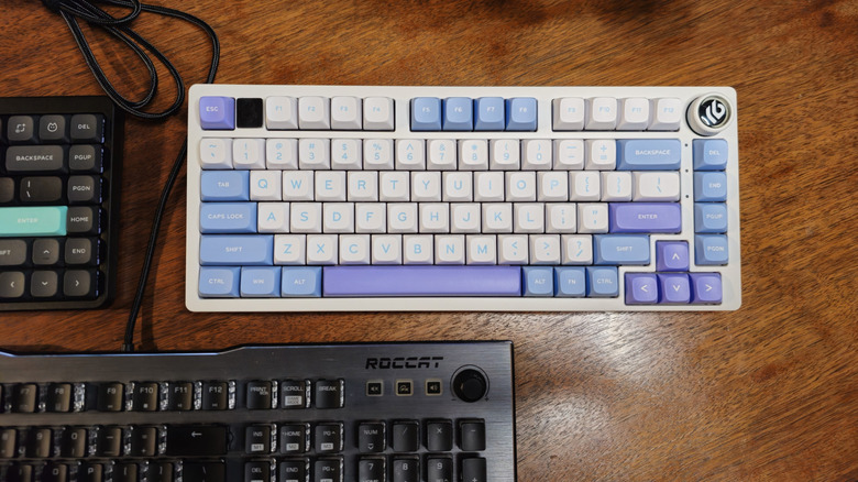 A NuPhy Air75 V2, Epomaker x LeoBog Hi75, and Roccat AIMO 100 on a desk