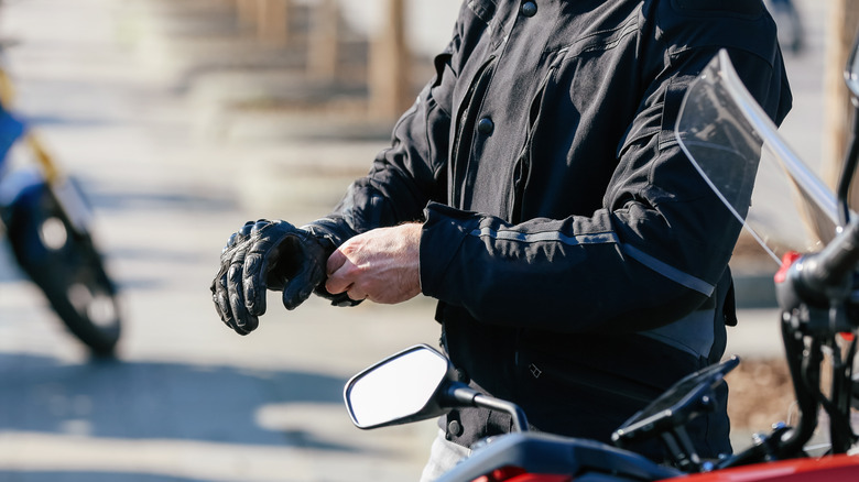 Motorcycle rider putting on gloves