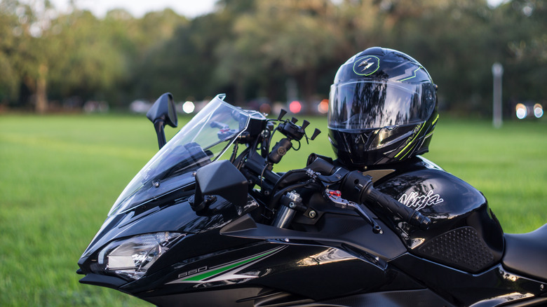 Scorpion full-face modular motorcycle helmet on the fuel tank of a 2017 black Kawasaki Ninja 650