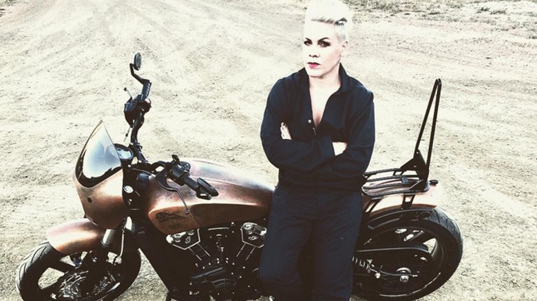 Pink leaning on motorcycle
