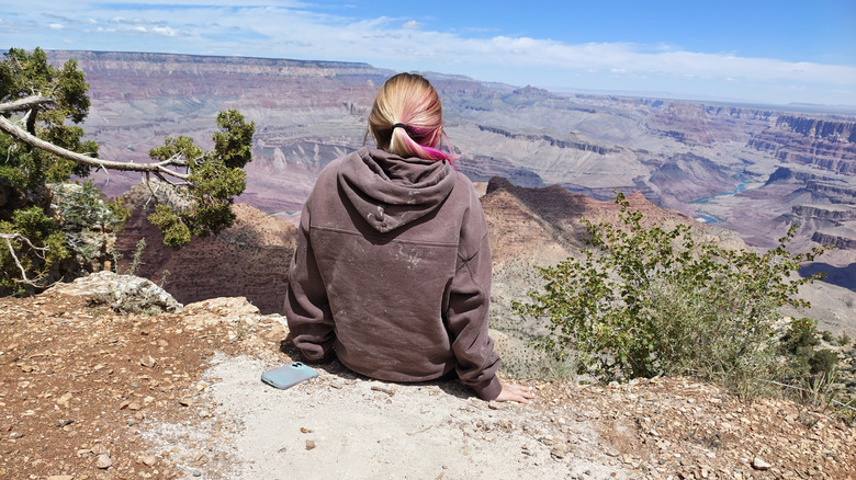 Woman sitting near the Grand Canyon