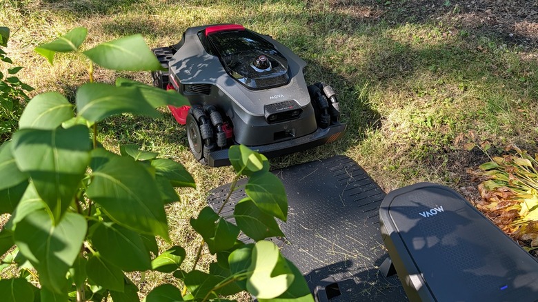 Mova lawn mower and base station charger.