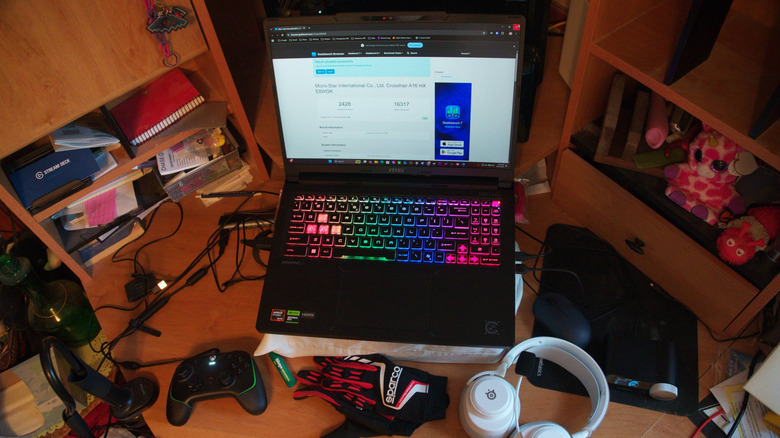 MSI Crosshair 16 sitting open on a desk with gaming peripherals