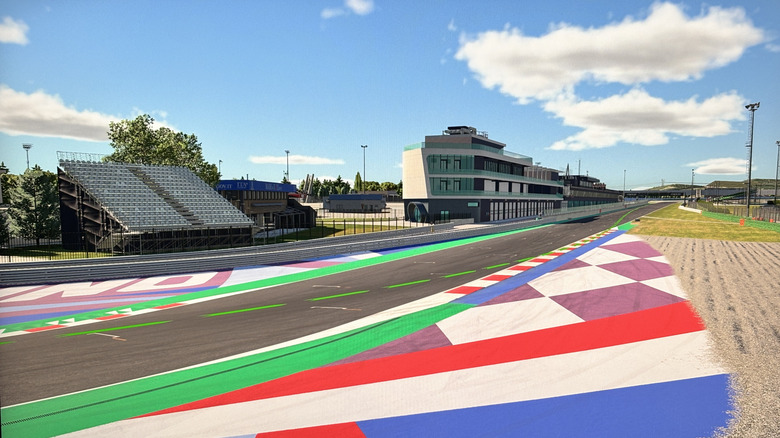 iPhone 15 photo of MSI Crosshair 16 screen, featuring a view of the grid of Misano World Circuit Marco Simoncelli in "iRacing"