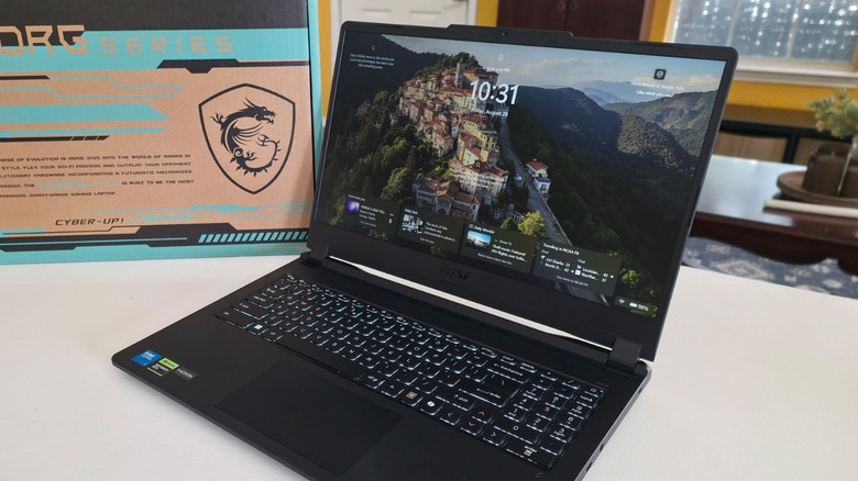 The MSI Cyborg 15 Max C2W showing the Windows 11 lock screen and the box