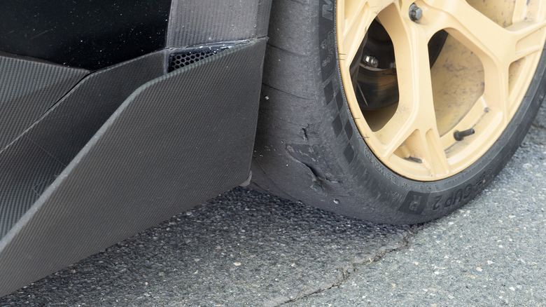 Mullen FIVE RS carbon fiber side skirt and shredded tire