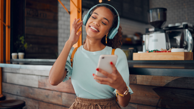 Woman listening to music via smartphone