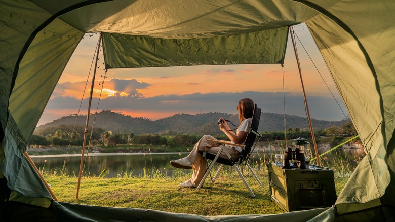 Woman sitting outside of tent