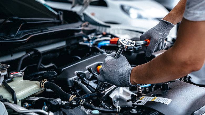 person repairing car