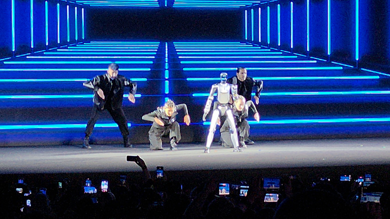 Honor robot with human dancers on stage