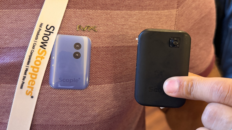 Man holding a Scople prototype next to a sticker showing the final product