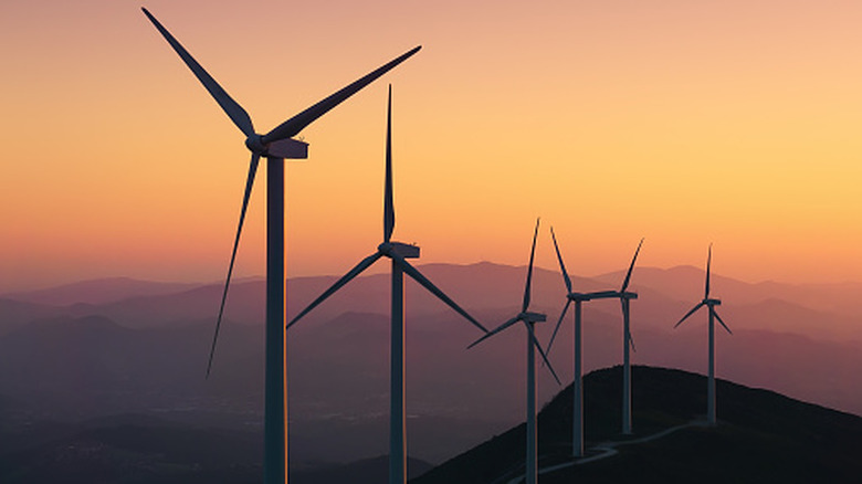 A group of wind turbines on top of a mountain
