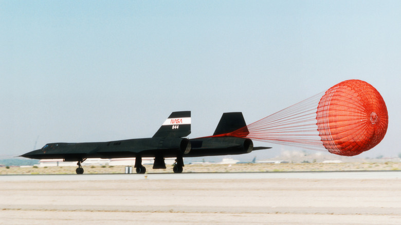 NASA Lockheed SR-71 Blackbird landing with parachute deployed.