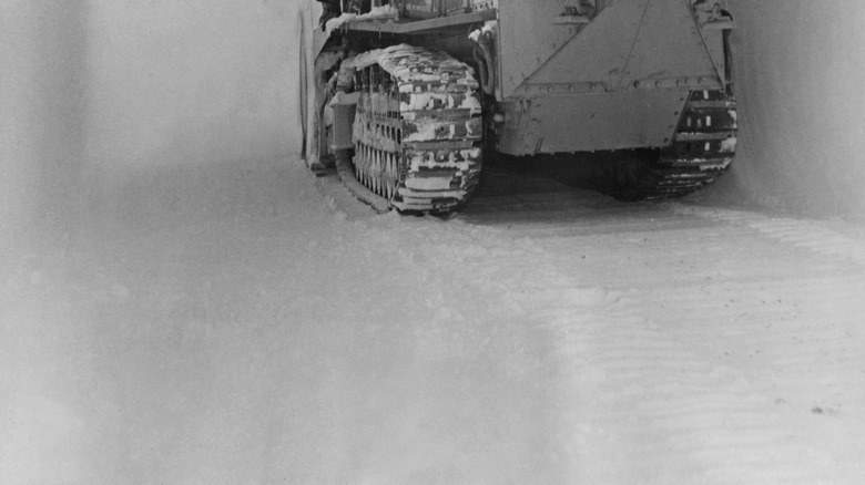 A person using heavy machinery to build Camp Century.