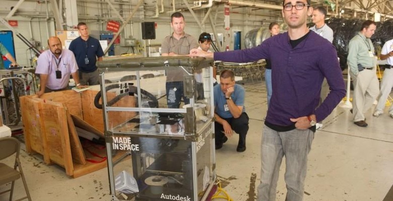 Made in Space CTO Jason Dunn displays a 3D Printing Test Experiment.