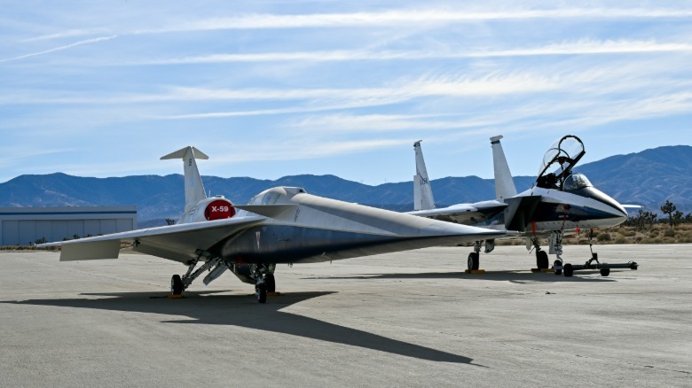 The NASA X-59 next to a NASA F-15D research plane
