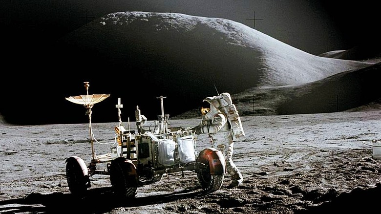 Astronaut James B. Irwin works at the rover 