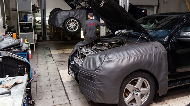 Front view of cars parked in dealership service bay.