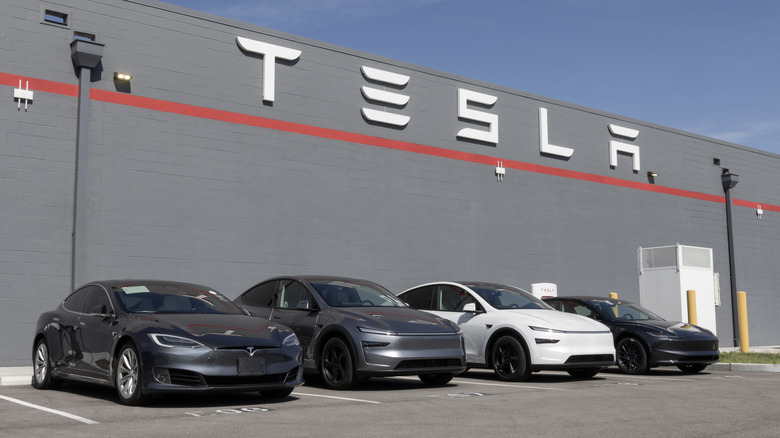 Exterior of Tesla dealership with vehicles parked out front