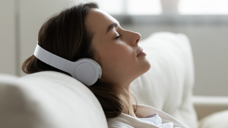 Woman listening to Bluetooth headphones