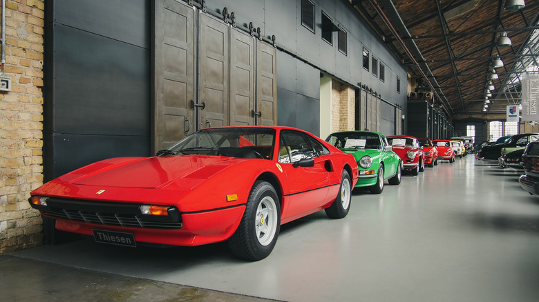 Classic cars lined up in building