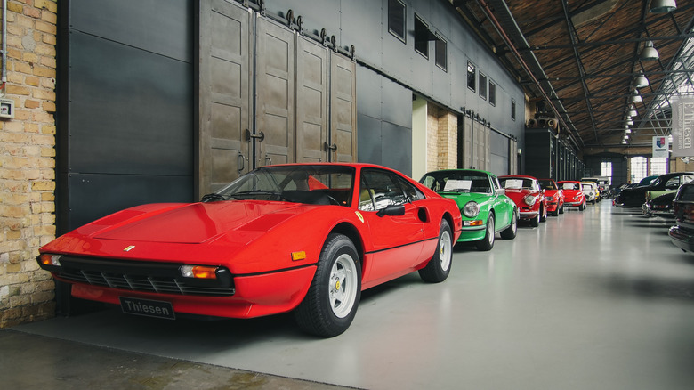 Classic cars lined up in building