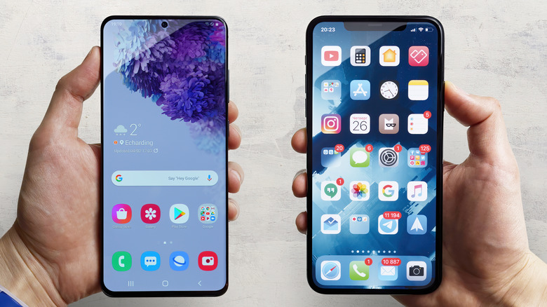 Holding iPhone Samsung phones
