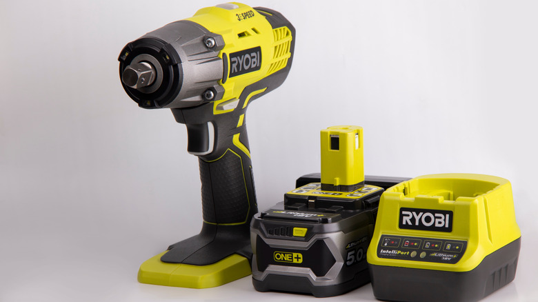 An image of a ryobi power tool drill with a charger and a battery