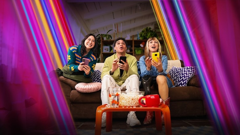 People playing Netflix Party Games on the couch with their phones