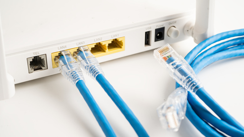 A Wi-Fi router with a USB port and ethernet cables