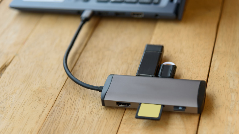 Close-up of a USB hub with multiple storage devices connected to it
