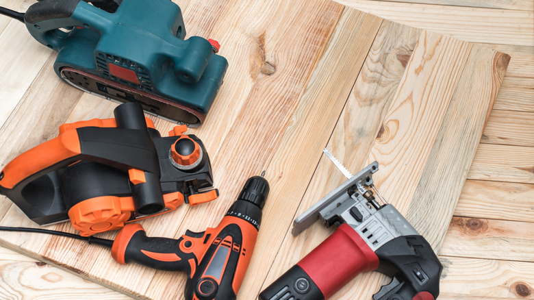 A bunch of woodworking power tools on a table