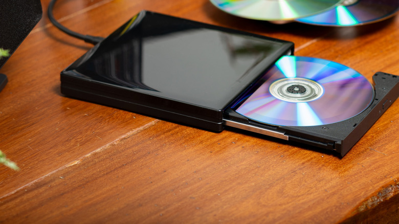 Portable external DVD, CD Drive connected to the laptop.