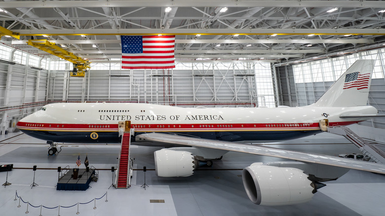 The New Air Force One jet with the side ramp stairs down in a hanger.