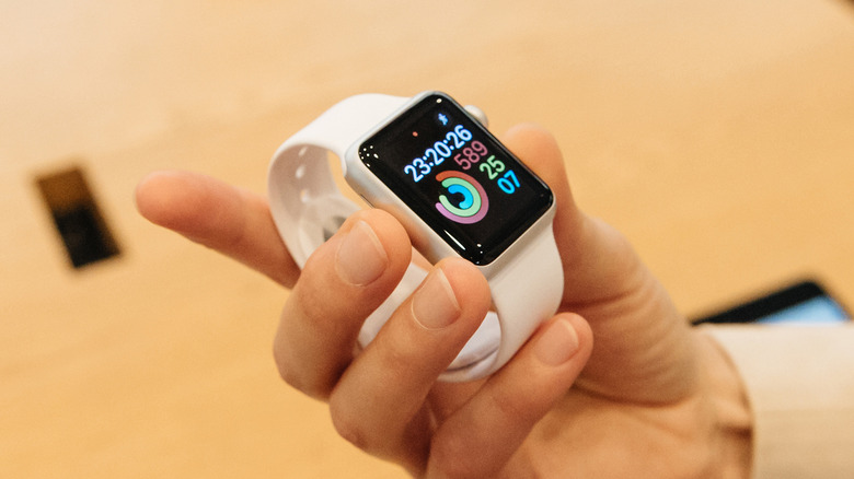 person holding Apple Watch