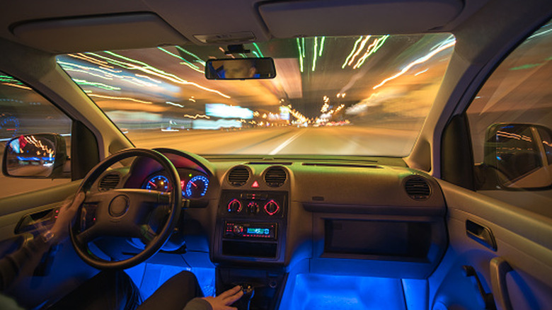 A car's interior with blue interior accent lights.