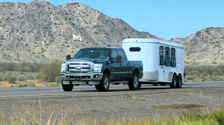 A Ford pickup towing a trailer.