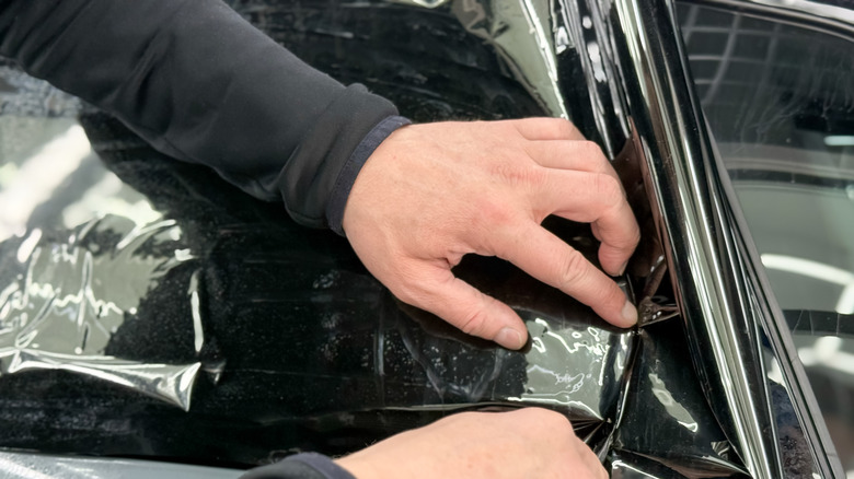 A professional applying tints to a window.