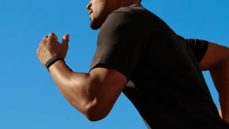A man wearing the Fitbit Air while running
