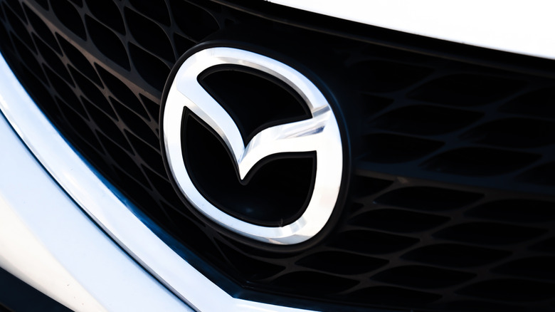 A Mazda logo on a white car