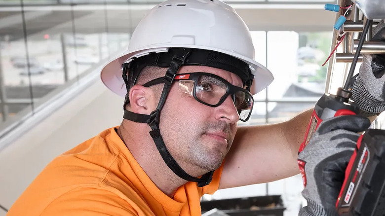 Full frame safety glasses being used by someone drilling.