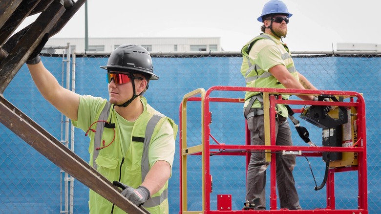 Workers wearing Milwaukee safety glasses