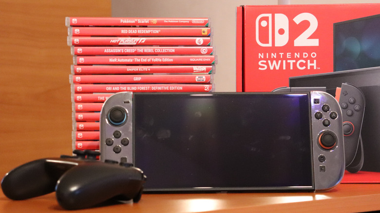 Nintendo Switch 2 console with Pro controller and stack of games