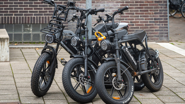 Three e-bikes on sidewalk