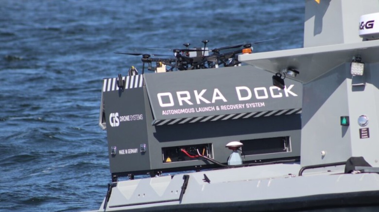 The ORKA Dock installed on the stern of a FLANQ-Q Recon 24 USV with a drone parked on top.