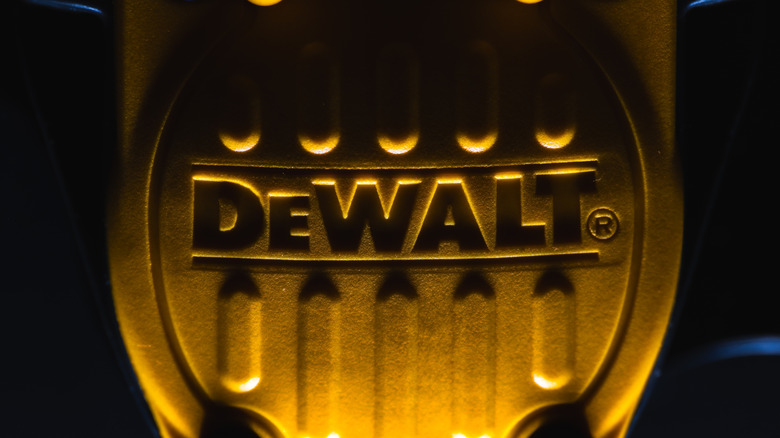 Closeup of a DeWalt badge on a tool.